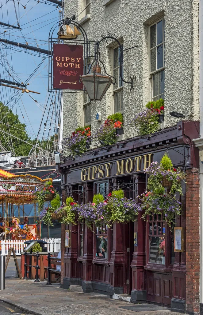 Exterior view of the Gipsy Moth pub in Greenwich, with Cutty Sark in the background