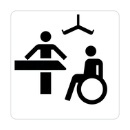 An icon representing a Changing Places toilet, showing a changing table, hoist and wheelchair user.