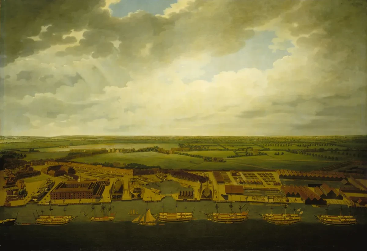 18th century view of Deptford Dockyard. The aerial perspective allows you to see the various wharves, buildings and docks that make up the facility, with the River Thames lined with ships in the foreground and open fields in the background