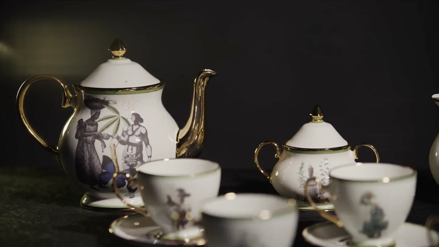 A tea set adorned with images of women and plants