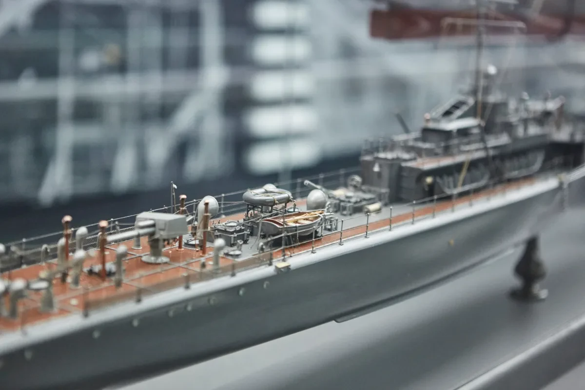 Close-up view of a model of a 20th century warship in a display cabinet.