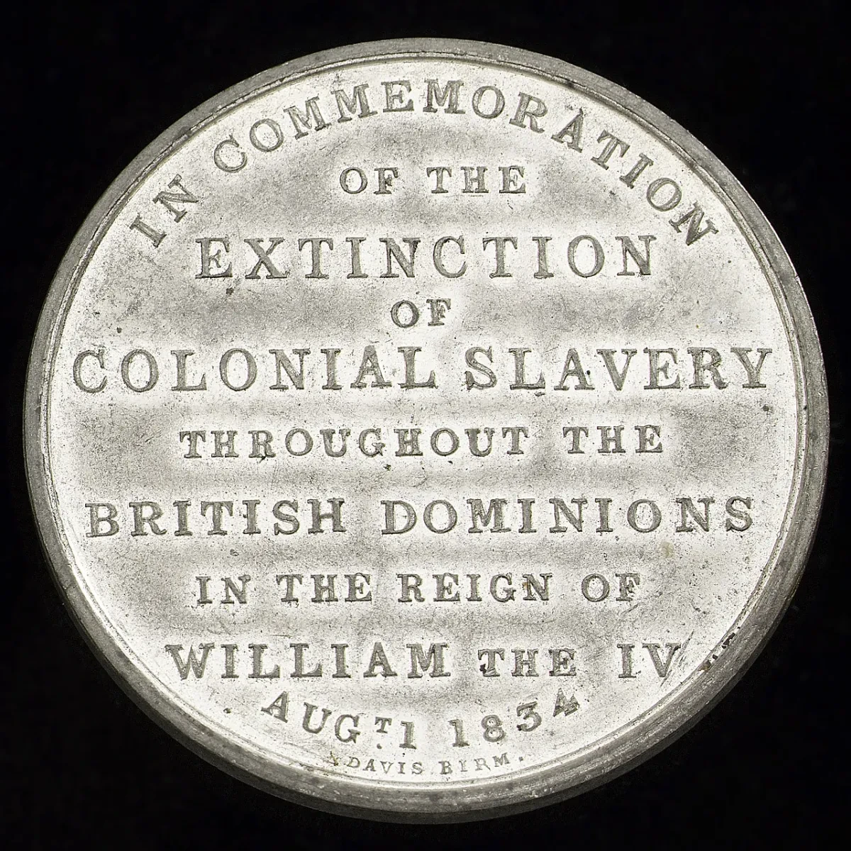 A silver medal commemorating the abolition of slavery. The embossed words read: 'In commemoration of the extinction of colonial slavery throughout the British dominions in the reign of William the IV - Aug 1 1834'