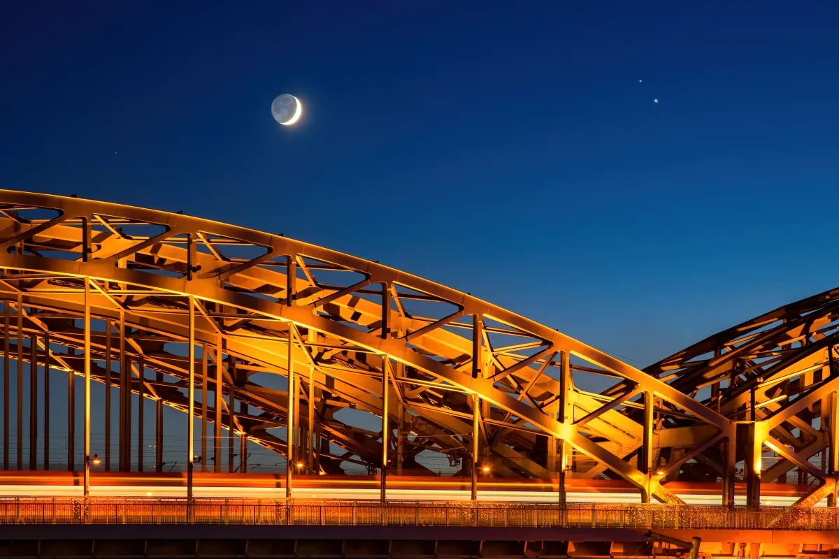Moon Crescent and Jupiter-Saturn Conjunction over suspension bridge