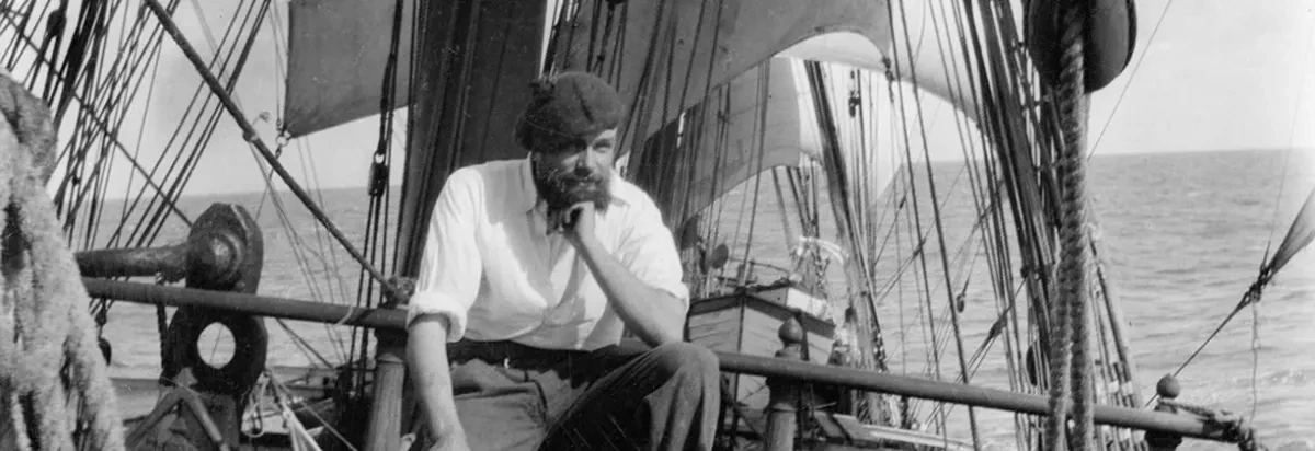 Black and white photograph of Alan Villiers on a ship's deck.