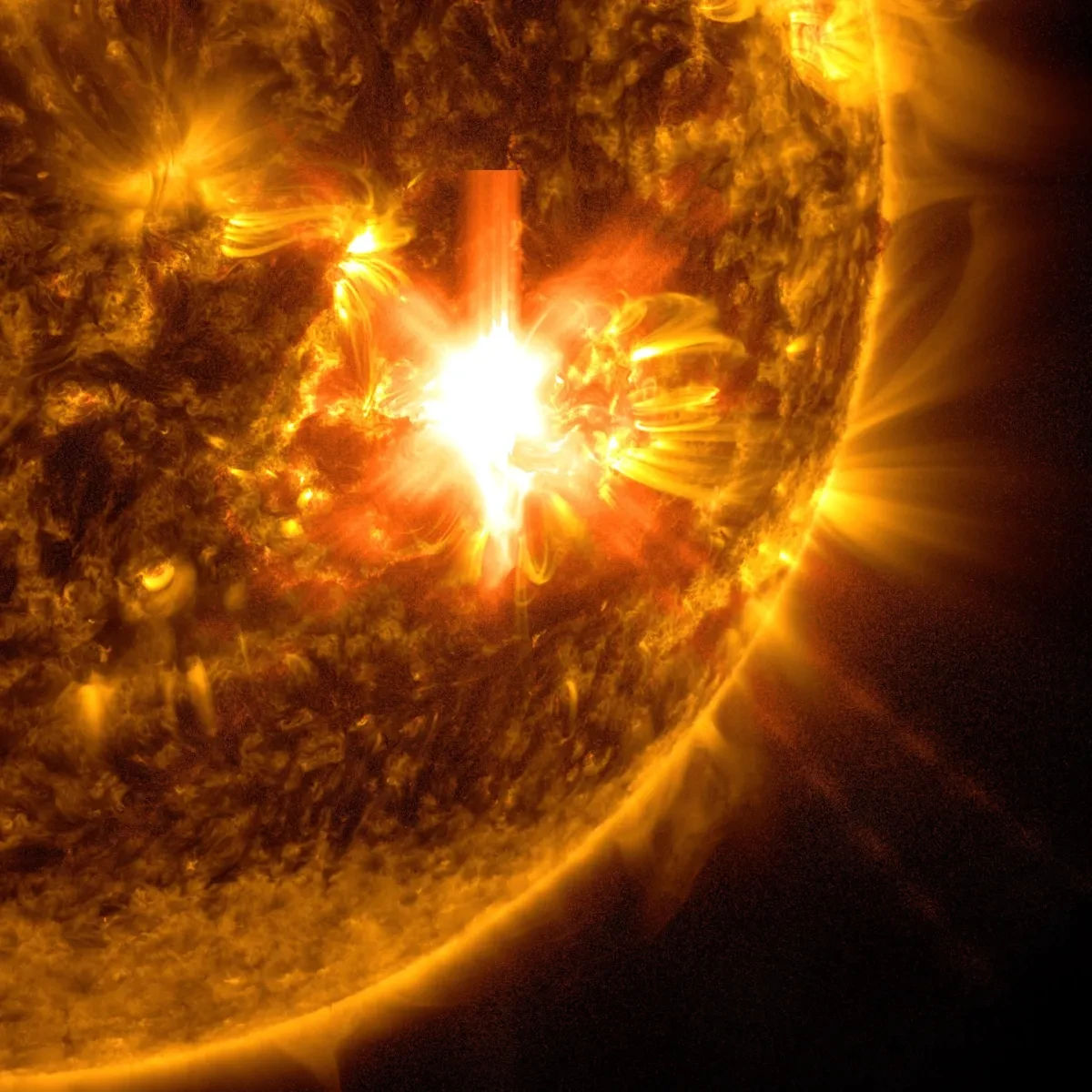 Photo of large solar flare shown as a bright white eruption on the Sun's surface
