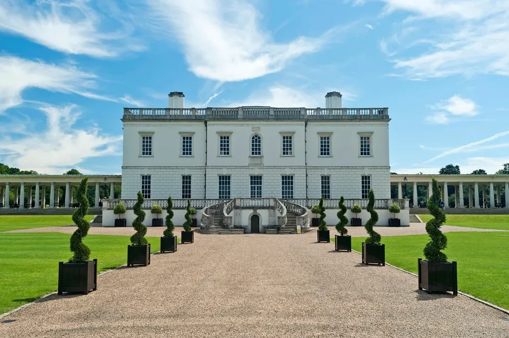 Looking up an ornamental tree-lined path to The Queen's House.
