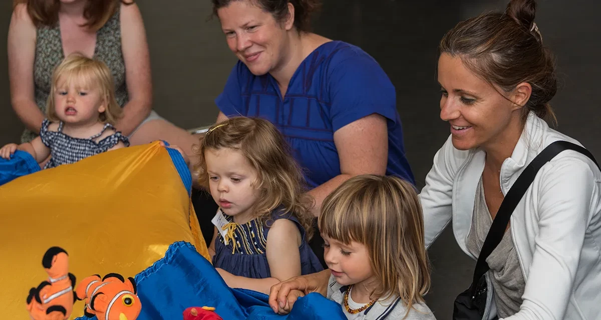 Toddlers and their parents playing.
