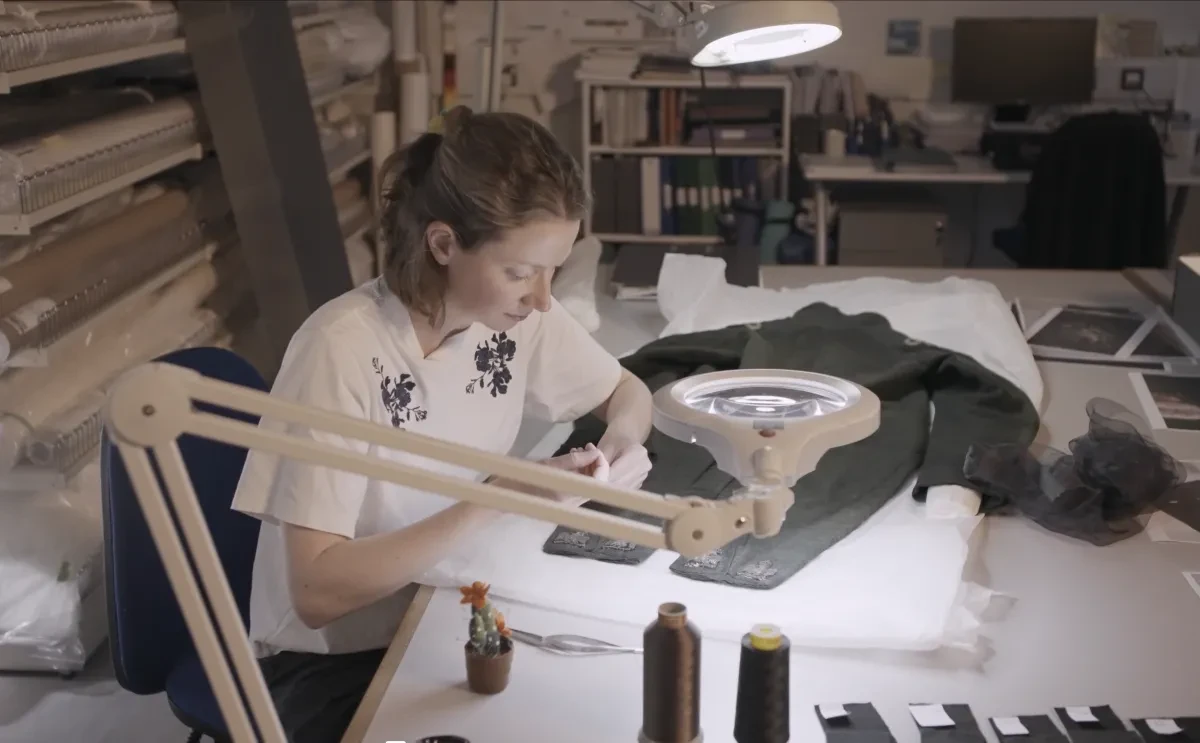 Conservator Aisling Macken working on the embroidered eagles on the Hare uniform