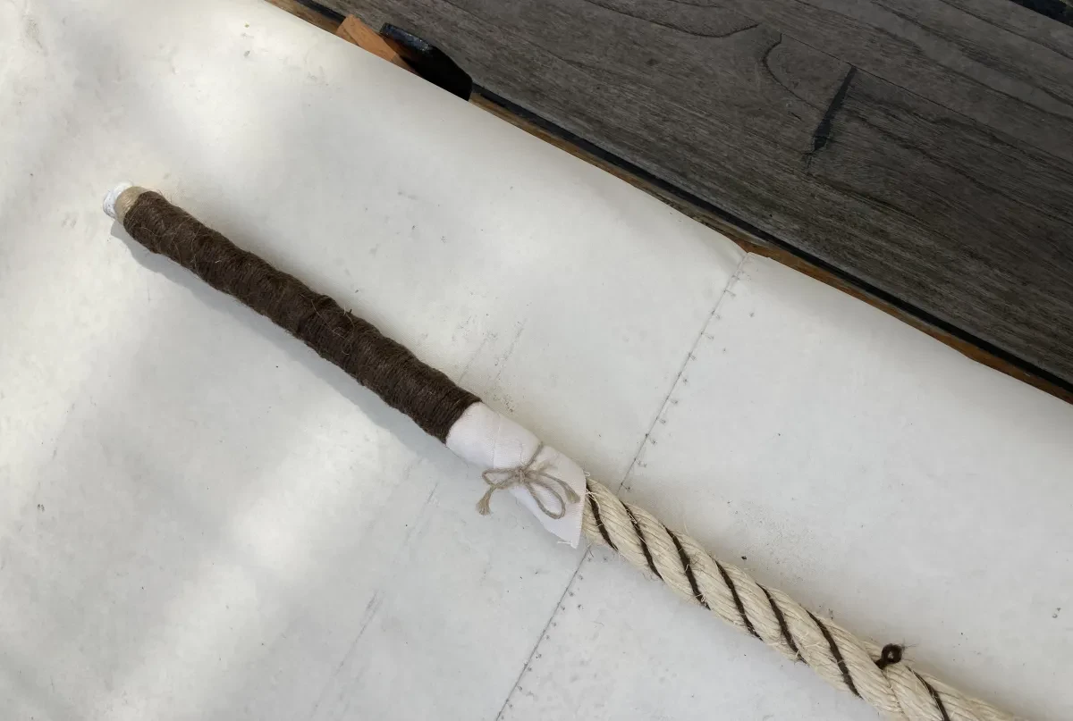 Image of end of piece of rope which has black wrap on end